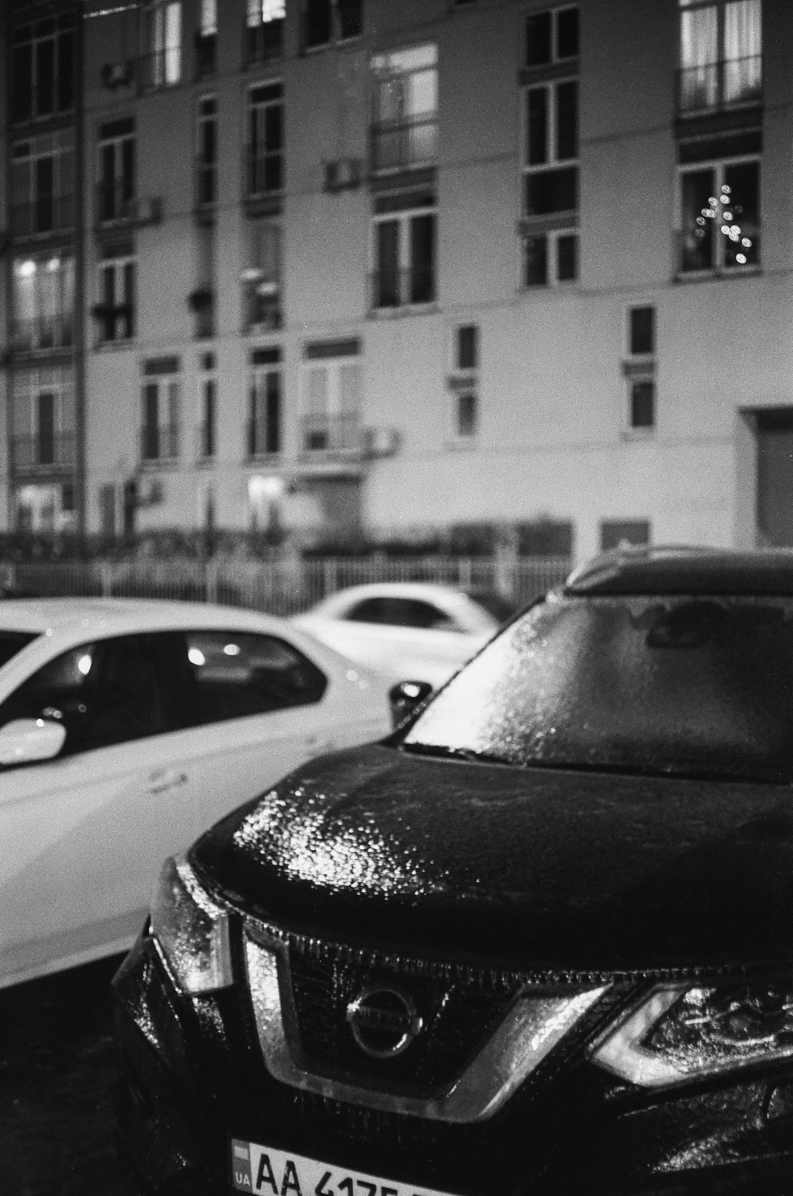 grayscale photo of cars parked on street